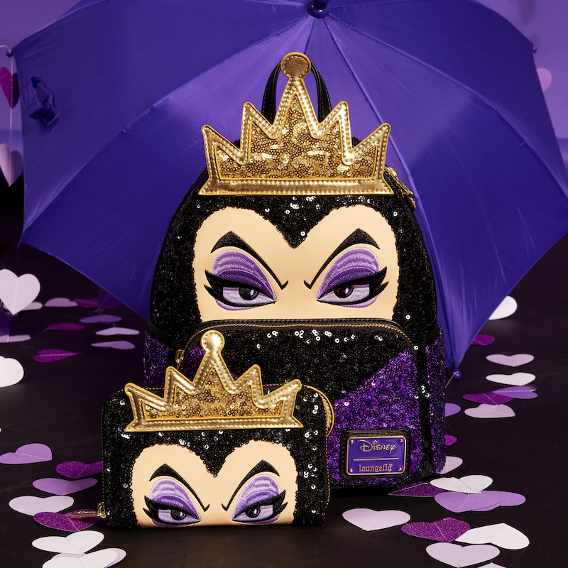 Black and purple Snow White Evil Queen Sequin mini backpack and wallet sitting in front of a purple umbrella with purple hearts scattered around them